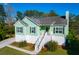 Charming elevated home with lush landscaping, stairs to entry, and a welcoming porch at 4281 Jacobs Point Ct, Ravenel, SC 29470