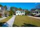 Lovely green home with a long driveway and well-manicured lawn in a picturesque neighborhood at 4281 Jacobs Point Ct, Ravenel, SC 29470