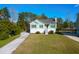 Charming single-story home with a green yard and a long driveway on a sunny day at 4281 Jacobs Point Ct, Ravenel, SC 29470