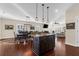 Open concept kitchen and living room features hardwood floors, pendant lighting, and an island with seating at 4281 Jacobs Point Ct, Ravenel, SC 29470