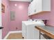 Functional laundry room with modern washer, dryer, and storage cabinets at 4281 Jacobs Point Ct, Ravenel, SC 29470