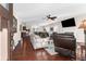 Spacious living room with hardwood floors, fireplace, and open floor plan to kitchen and dining area at 4281 Jacobs Point Ct, Ravenel, SC 29470