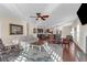 Open-concept living room flows into the kitchen, featuring a ceiling fan and access to the dining area at 4281 Jacobs Point Ct, Ravenel, SC 29470
