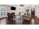 Cozy living room featuring a fireplace, plantation shutters, and comfortable seating arrangement at 4281 Jacobs Point Ct, Ravenel, SC 29470