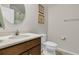 Well-lit bathroom with a wood vanity, white countertop, round mirror, and neutral paint at 458 Four Seasons Blvd, Summerville, SC 29486