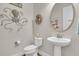 Stylish half bathroom with a round mirror, octopus decor, pedestal sink, and beach-themed accents at 458 Four Seasons Blvd, Summerville, SC 29486