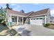 Charming home with a two-car garage, cozy front porch, beautiful stone accents, and well-manicured landscaping at 458 Four Seasons Blvd, Summerville, SC 29486