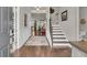 Welcoming foyer with hardwood floors, staircase, wainscoting and view into living area at 458 Four Seasons Blvd, Summerville, SC 29486