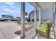 View from the cozy front porch showing a chair and view of neighborhood at 458 Four Seasons Blvd, Summerville, SC 29486