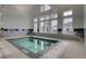 Relax in the indoor hot tub, featuring lots of windows, adjacent to the community's indoor pool at 458 Four Seasons Blvd, Summerville, SC 29486