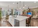 Open kitchen with a large island, stainless steel appliances, and views into a living space at 458 Four Seasons Blvd, Summerville, SC 29486
