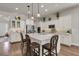 Bright kitchen features white cabinets, stainless appliances, an island, and stylish pendant lighting at 458 Four Seasons Blvd, Summerville, SC 29486