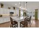 Spacious kitchen with island, seating, pendant lights, and stainless steel appliances overlooking the dining area at 458 Four Seasons Blvd, Summerville, SC 29486