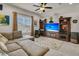 Comfortable living room with a large sectional sofa, entertainment center, and ceiling fan at 458 Four Seasons Blvd, Summerville, SC 29486