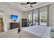 Bright main bedroom with mounted television, carpet, and three windows with a wooded backyard view at 458 Four Seasons Blvd, Summerville, SC 29486