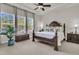 Spacious main bedroom featuring a dark wood bed frame, carpet, and large windows at 458 Four Seasons Blvd, Summerville, SC 29486