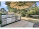 An outdoor kitchen with stainless steel appliances and stone accents sits under a large umbrella at 458 Four Seasons Blvd, Summerville, SC 29486