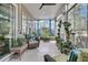 Cozy sunroom featuring bright cushions, a ceiling fan, and views of the wooded backyard at 458 Four Seasons Blvd, Summerville, SC 29486