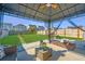 Well-kept backyard with a patio, gazebo, outdoor furniture, stepping stones, and green grass at 458 Whispering Breeze Ln, Summerville, SC 29486