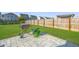 Spacious backyard with paver patio, grill, and lush green lawn surrounded by a wooden fence at 458 Whispering Breeze Ln, Summerville, SC 29486