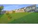 Expansive backyard featuring a wooden fence, mature trees, lush lawn, and a patio with a grill at 458 Whispering Breeze Ln, Summerville, SC 29486