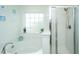 Bright bathroom featuring a large soaking tub and a glass enclosed shower with chrome trim at 458 Whispering Breeze Ln, Summerville, SC 29486