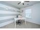 Study room with a white executive desk with chair and striped accent wall at 458 Whispering Breeze Ln, Summerville, SC 29486