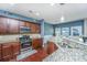 Stylish kitchen showcasing granite countertops, stainless steel appliances, and dark wood cabinetry at 458 Whispering Breeze Ln, Summerville, SC 29486