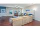 Inviting living room featuring hardwood floors, a large sofa, TV, and ample natural light at 458 Whispering Breeze Ln, Summerville, SC 29486