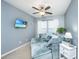 Cozy living room featuring a comfortable sofa, ceiling fan, and a mounted television for entertainment at 458 Whispering Breeze Ln, Summerville, SC 29486