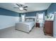 Serene main bedroom boasts a plush bed, neutral tones, ceiling fan, and ample natural light at 458 Whispering Breeze Ln, Summerville, SC 29486