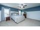 Serene main bedroom boasts a plush bed, neutral tones, ceiling fan, and ample natural light at 458 Whispering Breeze Ln, Summerville, SC 29486