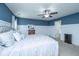 Serene main bedroom boasts a plush bed, neutral tones, ceiling fan, and ample natural light at 458 Whispering Breeze Ln, Summerville, SC 29486