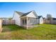 A spacious backyard with a green lawn and a screened-in porch at 5020 Holdsworth Dr, Summerville, SC 29485