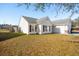 Well-maintained single-story home with white siding and a manicured front lawn on a sunny day at 5020 Holdsworth Dr, Summerville, SC 29485