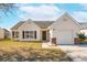 Charming one-story home featuring a garage, brick accents, and a well-kept front yard at 5020 Holdsworth Dr, Summerville, SC 29485