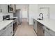 Modern kitchen featuring stainless steel appliances, gray cabinets, and white countertops at 5020 Holdsworth Dr, Summerville, SC 29485