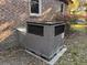 Exterior view of the AC unit on a red brick home with blossoming azalea bushes at 5310 Edith St, North Charleston, SC 29418