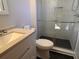 Modern bathroom showcasing new vanity, toilet and walk-in shower with sleek black tile flooring at 5310 Edith St, North Charleston, SC 29418
