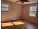 Bedroom with natural light, hardwood floors, two windows with outdoor views and neutral wall color at 5310 Edith St, North Charleston, SC 29418