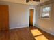 Bedroom with hardwood floors, neutral wall color, ceiling fan and open doorway leading to another room at 5310 Edith St, North Charleston, SC 29418