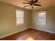 Bedroom features hardwood floors, green walls, a ceiling fan and two windows at 5310 Edith St, North Charleston, SC 29418