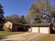 Charming single-story brick home featuring an attached two-car garage and driveway at 5310 Edith St, North Charleston, SC 29418