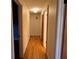 Hallway features hardwood floors, neutral paint and modern light fixtures at 5310 Edith St, North Charleston, SC 29418
