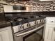 Stainless steel Samsung gas range with mosaic backsplash and black countertop at 5310 Edith St, North Charleston, SC 29418