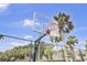 Outdoor fenced basketball court available for residents with beautiful palm trees in the background at 60 Fairway Dunes Ln, Isle of Palms, SC 29451