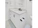 Bathroom features a modern vanity with marble countertop, fixtures, and a tiled floor at 60 Fairway Dunes Ln, Isle of Palms, SC 29451