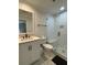 Bathroom with a glass shower, tiled floors and shower, and white cabinets with black hardware at 60 Fairway Dunes Ln, Isle of Palms, SC 29451