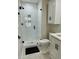 Bathroom with a glass shower, tiled floors and shower, and white cabinets with black hardware at 60 Fairway Dunes Ln, Isle of Palms, SC 29451