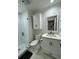 Bathroom with a glass shower, tiled floors and shower, and white cabinets with black hardware at 60 Fairway Dunes Ln, Isle of Palms, SC 29451